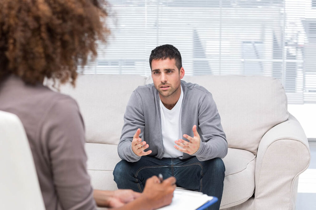 man on couch talking with therapist about personality disorders and substance abuse