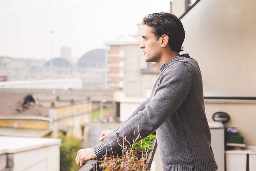 man looking out on city considers are you self-medicating