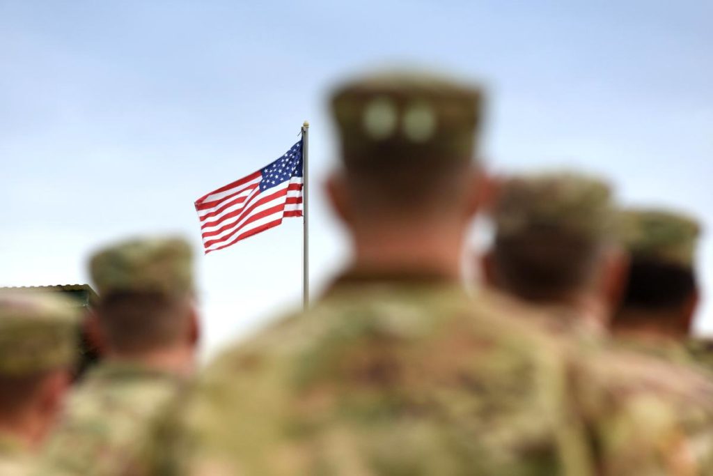 veterans in front of american flag