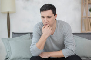 man in sweater considers anxiety and addiction