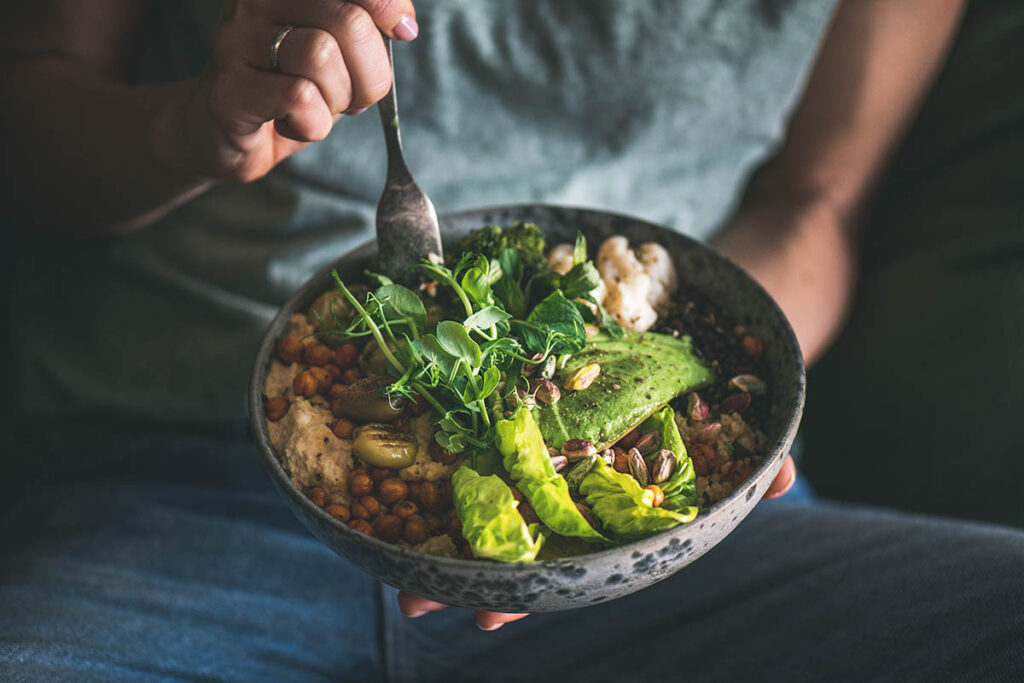eating a bowl of veggies and grains while learning about diet during addiction recovery
