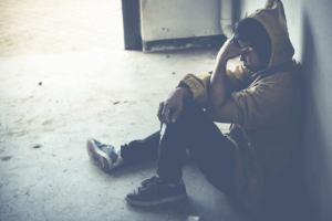 person sitting on floor considers benzo overdose symptoms