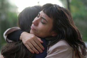 a woman hugs another woman after understanding the the issues women face in addiction recovery